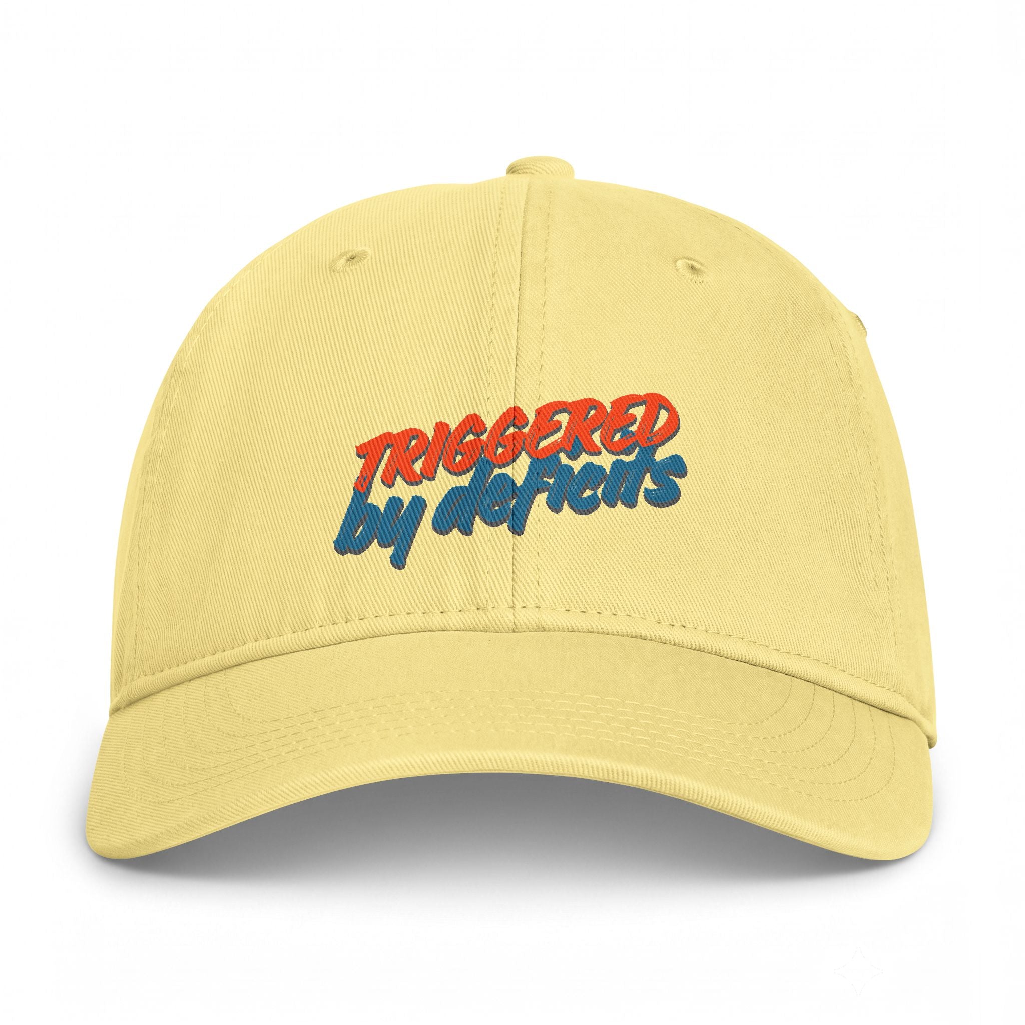 Yellow cap with 'TRIGGERED BY DEFICITS' text in multicolor on a white background